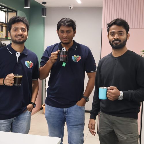 Three male colleagues from Creditsafe India posing for a photo together smiling.