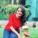 Prerna Khardekar posing with a company award trophy