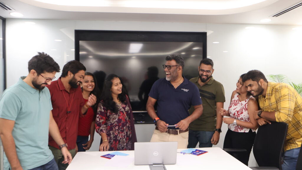 Our Managing Director, Kishore, laughing with colleagues at a presentation meeting