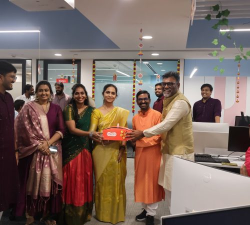 Members of our team posing with a gift-box during our Diwali event