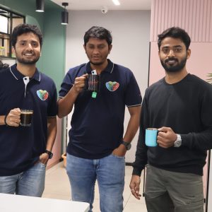 Three male colleagues from Creditsafe India posing for a photo together smiling.